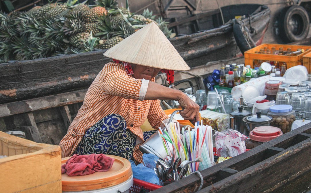A vendor selling drinks from a boat on the Mekong River