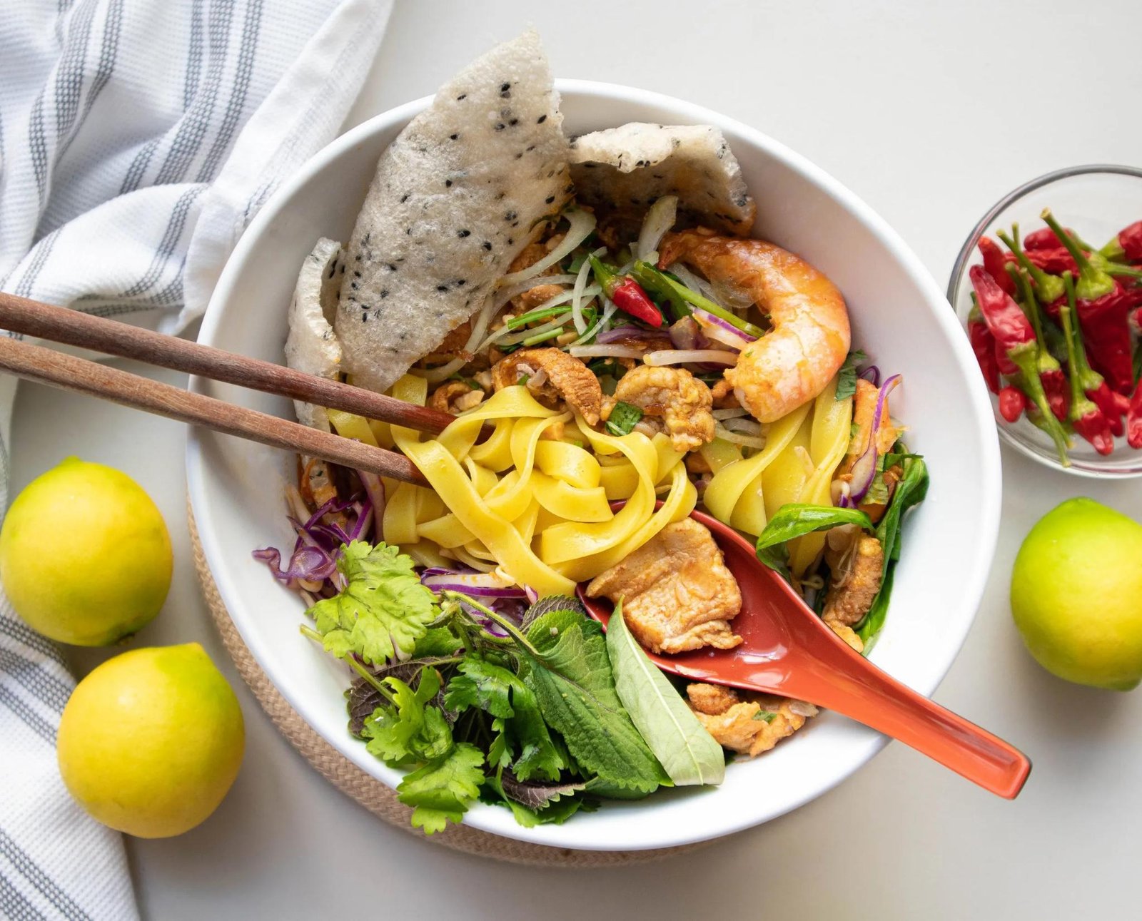 Mì Quảng noodles with prawns, fresh herbs and rice cracker